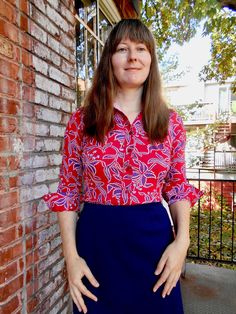 Psychedelic 70s shirt with a vibrant red/blue colour combo and amazing tropical flower print. Buttons up the front and closes with two buttons at the cuff. Classic 70s pointy collar. The floral print is in tones of deep blue, light blue, and white. Label: Kmart Materials: 100% Polyester Condition: Good vintage condition. There is some light pilling along the hem and three small pulls in the fabric - these are hard to see in the busy print. Price has been reduced to take account of these flaws. M Red Blouse With Button Cuffs For Spring, Red Floral Print Retro Shirt, Retro Red Floral Print Shirt, Red Retro Floral Print Shirt, Vibrant Red Floral Print Blouse, Retro Floral Print Button-up Top, Vintage Red Blouse With Button Closure, Red Vintage Blouse With Button Closure, Red Floral Print Button-up Blouse