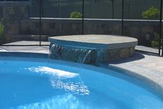 a small pool with a waterfall in the middle