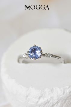 Discover the perfect symbol of love and commitment with our magical pastel blue sapphire engagement ring.
The 0.75 carat blue sapphire sits elegantly in a solitaire setting, surrounded by 8 round prongs and set on a 14k white gold band with two sets of 3 round graduated side diamonds add the perfect touch of sparkle to this beautiful and elegant design. 
Make your proposal unforgettable with this timeless piece. Blue Sapphire Solitaire Promise Ring, Light Blue Round Sapphire Promise Ring, Blue Solitaire Birthstone Promise Ring, Blue Sapphire Round Cut Promise Ring, Blue Solitaire Birthstone Ring For Promise, Blue Sapphire Promise Ring With Round Cut, Blue Diamond Solitaire Birthstone Ring, Blue Sapphire Birthstone Ring For Proposal, Blue Birthstone Ring With Brilliant Cut For Promise