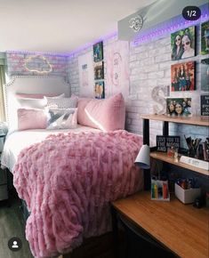 a bedroom with pink bedding and pictures on the wall