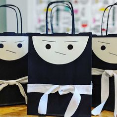 three black and white bags with faces on them