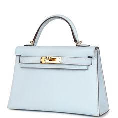 This Kelly, in the Sellier style, is in Bleu Brume epsom leather with gold hardware and has tonal stitching, two straps with front toggle closure, single rolled handle and removable shoulder strap.The interior is lined with Bleu Brume lambskin leather and has one open pocket on the back wall.Collection: YOrigin: FranceCondition: New and never worn (plastic on hardware)Accompanied by: Hermes box, Hermes dustbag, shoulder strap, shoulder strap dustbag, feltMeasurements: 7.5" width x 4.5" height x 2.2" depth; 2.5" handle drop (18" shoulder strap drop) Hermes Collection, Kelly Hermes, Hermes Kelly Sellier, Kelly Sellier, Mini Kelly, Blue Handbag