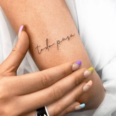 a woman's arm with the word tattoo on it