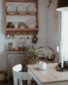 a dining room table with plates and cups on it