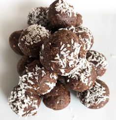 a pile of chocolate truffles with coconut sprinkles and shredded white sugar