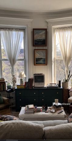 a living room filled with furniture and lots of windows