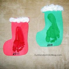 two handprinted christmas stockings on brown paper