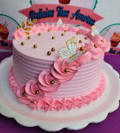 there is a pink cake with gold decorations on it