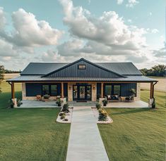 a house that is in the middle of a grassy area with a walkway leading to it