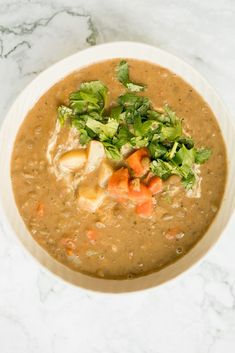 a white bowl filled with soup and vegetables