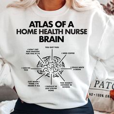 a woman wearing a sweatshirt that says atlas of a home health nurse brain