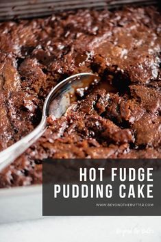 a close up of a cake in a pan with a spoon on the side and text overlay that reads hot fudge pudding cake