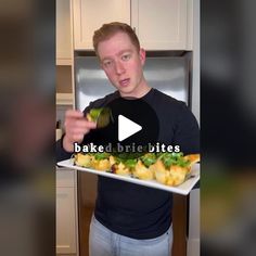 a man holding a plate with food on it and the words baked brie bites in front of him