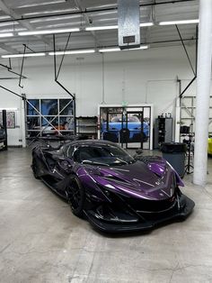 a purple sports car parked in a garage