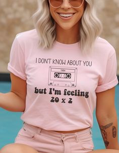 a woman with white hair wearing a pink t - shirt that says i don't know about you but i'm feeling 20 x 2