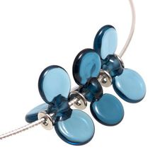 a necklace with blue glass flowers on it