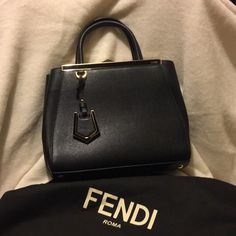 Fendi Black Leather Purse With Gold Hardware. Includes Shoulder Strap And Dust Bag. Used 3 Times. Purchased At Fendi Crystal Mall In Las Vegas. 10” Base Width Height From Top Of Handles 12” Height Of Bag 8 1/2” X 4” Fendi Crossbody Bag Cross Body Purses, Fendi Crossbody Baguette, Fendi Baguette Leather Bag, Black Fendi Bag, Fendi Purse Strap, Black Leather Purse, Fendi Bags, Gold Hardware, Leather Purses