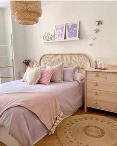 a bedroom with a bed, dresser and rug