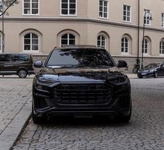 a black suv parked on the side of a street