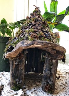 a house made out of logs and pine cones