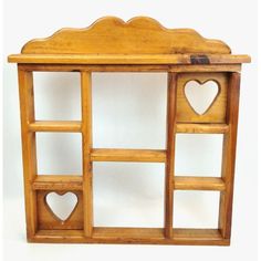 a wooden shelf with two hearts on the top and shelves below it that are attached to each other