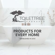 a white bath tub sitting under a window next to a wall mounted sign that reads, products for every home established in 2010