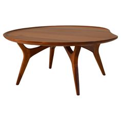 an oval wooden table with two legs and a circular top, on a white background