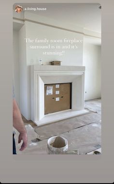 a man standing in front of a white fireplace