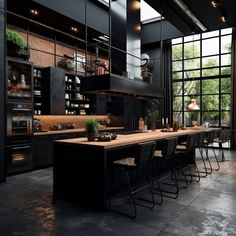 a large kitchen with lots of counter space and black cabinets, along with an island in the middle