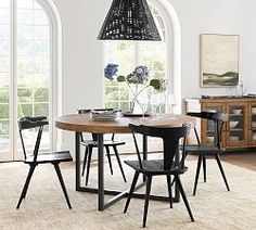 a dining room with arched windows and an area rug on the floor that has various chairs around it