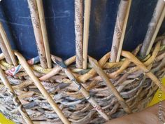 a person holding a basket full of wooden crochet hooks with words written on them