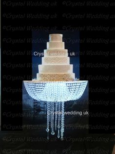 a wedding cake with icing hanging from it's sides and the top tier is covered in crystal beads