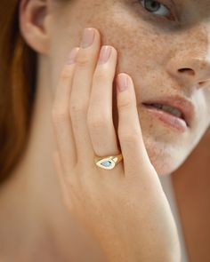 Inspired by the blue tones of the sky, the Pear Sky Signet showcases a unique blue Skydiamond. The east/west setting creates a modern sculptural ring, inspired by the bringing together of the traditional and contemporary has created a comfortable ring for everyday wear. This symbolic piece is destined to mark those important life moments; whether a significant birthday, life event or an alternative engagement option, each ring in the collection is ready to purchase, or can be created demi-bespoke, by altering metal or stone weight colour or cut. Or, by working with the in-house design team at Skydiamond to create a completely bespoke piece designing an emblem that is true to your individual values. Modern Blue Jewelry For Promise, Timeless Blue Gemstone Signet Ring, Luxury Blue Ring With Tension Setting, Modern Blue Sapphire Promise Ring, Modern Blue Topaz Ring For Wedding, Modern Blue Topaz Wedding Ring, Modern Blue Solitaire Jewelry, Modern Blue Topaz Ring Jewelry, Modern Marquise Cut Gemstone Rings