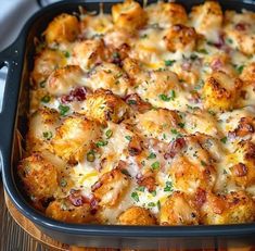 a casserole dish with meat and cheese in it on a wooden table top