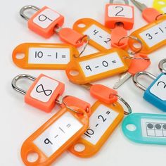 several different colored key chains with numbers on them and keys attached to each one's sides