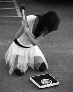 a woman kneeling on the ground holding a tennis racquet next to a tablet