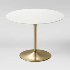 a round white table with a gold base