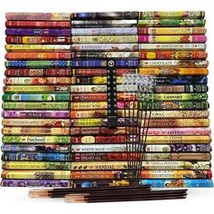 a large stack of books with a remote control on top of it, surrounded by many different types of books