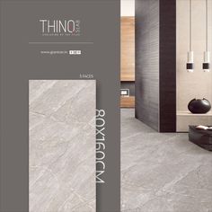 the interior of a modern living room with grey marble flooring