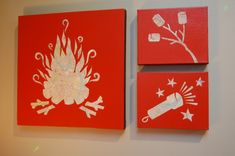 two red paintings with white designs on them