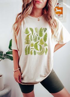 "Cottagecore Shirt | Botanical Shirt Women | Fern Shirt Women | Bluestar Fern | Lemon Button Fern | Crocodile Fern | I Love Ferns | Comfort Colors Shirt | Plant Mom Shirt Size Chart Available as the last image, The color in the main image is \"Ivory\"  Comfort Colors brand tees are a garment-dyed t-shirt, a fully customizable tee made 100% with ring-spun cotton. The soft-washed, garment-dyed fabric brings extra coziness to your wardrobe while the relaxed fit makes it an excellent daily choice. The double-needle stitching throughout the tee makes it highly durable while the lack of side-seams helps the shirt retain its tubular shape. - 100% ring-spun cotton - Medium fabric  - Relaxed fit - Sewn-in twill label PROCESSING TIME & SHIPPING: My products are made to order and they take 4-6 days o Lemon Button Fern, Crocodile Fern, Button Fern, Leaf Shirt, Shirt Size Chart, Cottagecore Shirt, Botanical Vintage, Botanical Shirt, Fern Plant