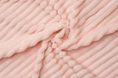 the texture of a blanket is soft pink