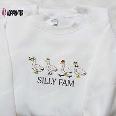 The Silly Fam Goose Embroidered Shirt is the ultimate blend of style and humor. Made with high-quality materials, this shirt features a cute goose embroidery that will surely make heads turn. Its comfortable fit and soft fabric ensure all-day comfort. With this shirt, you can effortlessly showcase your fun-loving personality and make a statement wherever you go. Perfect for casual outings and social gatherings, it adds a touch of whimsy to any outfit. Stand out from the crowd and spread laughter Fall Embroidered Crew Neck Shirt, Embroidered Crew Neck Shirt For Fall, Funny White Long Sleeve Shirt, Goose Embroidery, Cute Goose, Embroidered Shirts, Animal Funny, Silly Goose, Take Responsibility