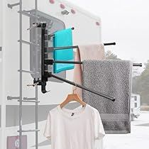 an rv with clothes hanging from it's rack and two shirts on the hanger