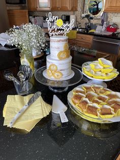 a table topped with cakes and desserts covered in frosting sitting on top of a counter