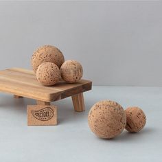 three corks sitting on top of a wooden table next to two small stools