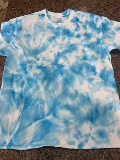 a blue and white tie - dyed t - shirt laying on top of a counter