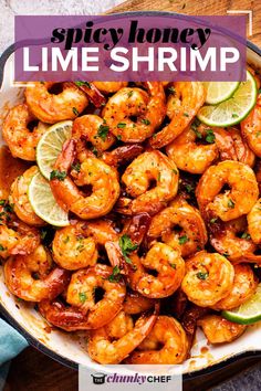 the recipe for spicy honey lime shrimp is in a skillet with lime wedges