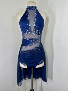 a dress on a mannequin with white dots