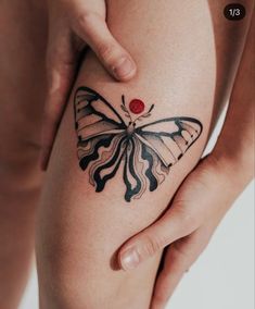 a woman's leg with a butterfly tattoo on the side of her thigh,